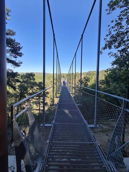 Elevated pedestrian bridge made of pressed metal grating